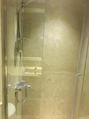 a shower in a bathroom with a glass door at Sabina Comfort Residence in Hurghada