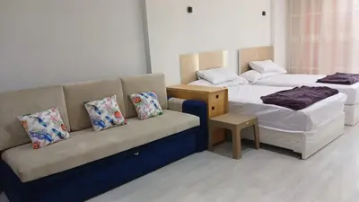 a hotel room with two beds and a couch at Mirage bay aquapark and resort 110 C minaland in Hurghada
