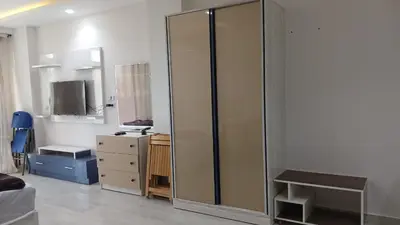 a room with a large glass cabinet and a dresser at Mirage bay aquapark and resort 110 C minaland in Hurghada