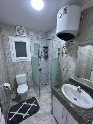 a bathroom with a toilet and a sink and a shower at Luxurious Apartment in Selena Bay - Private Beach, 5 Pools and Kite Surfing in Hurghada