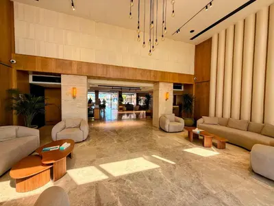 a lobby with couches and tables in a building at Luxurious Apartment in Selena Bay - Private Beach, 5 Pools and Kite Surfing in Hurghada
