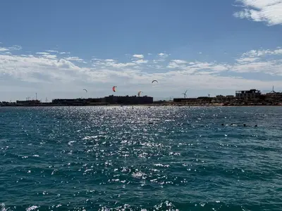 a group of kites flying over a body of water at Luxurious Apartment in Selena Bay - Private Beach, 5 Pools and Kite Surfing in Hurghada