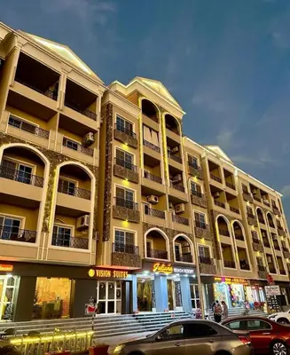 a large building with cars parked in front of it at Juliana Beach Resort Hurghada D402 in Hurghada