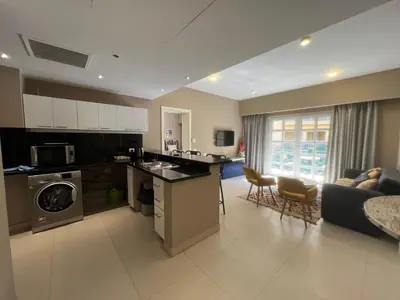 a large kitchen and living room with a couch at Elegant 2BR Apartment • Ocean View Abu Tig Marina in Hurghada