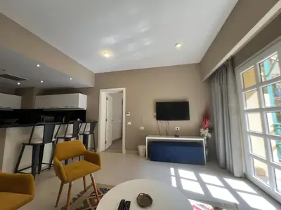 a living room with a large window and a tv at Elegant 2BR Apartment • Ocean View Abu Tig Marina in Hurghada