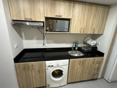a small kitchen with a sink and a washing machine at Scandic resort in Hurghada