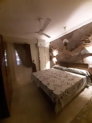 a bedroom with a bed and a ceiling fan at Horus Heights in Idfu