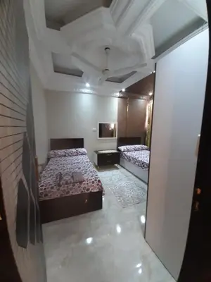 a bedroom with two beds and a mirror at Horus Heights in Idfu