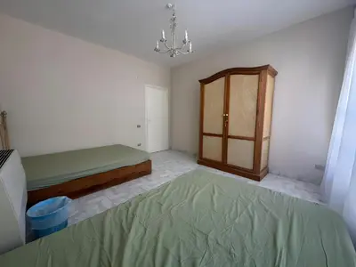 a bedroom with a bed and a wooden cabinet at 4 Bedroom Seaside Hurghada Escape in Hurghada