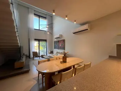 a dining room and living room with a table and chairs at Bohemian-Style 3BR Townhouse in Shedwan, El Gouna. in Hurghada