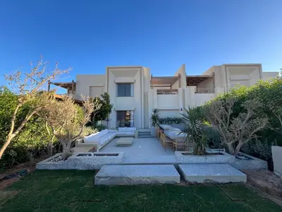 a large white house with trees and a yard at Bohemian-Style 3BR Townhouse in Shedwan, El Gouna. in Hurghada