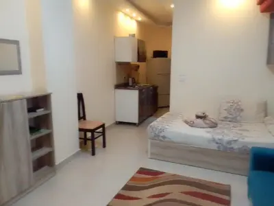 a small room with a bed and a kitchen at Casablanca Beach Appartment in Hurghada
