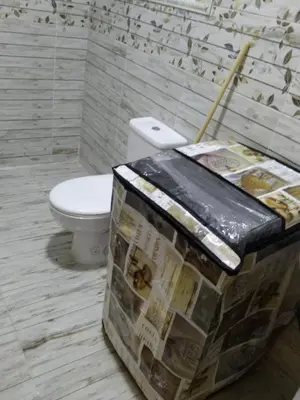 a bathroom with a toilet and a newspaper dispenser at Casablanca Beach Appartment in Hurghada