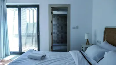 a bedroom with a white bed and a large window at Luxurious 5bdrooms villa Somabay in Hurghada