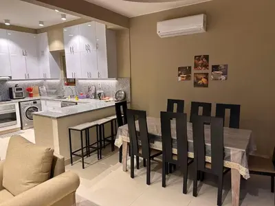 a kitchen with a table and chairs and a counter at Exclusive Villa in Sabina • 4 BR • Private Pool in Hurghada