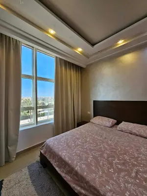 a bedroom with a bed and a large window at touristic center in Hurghada
