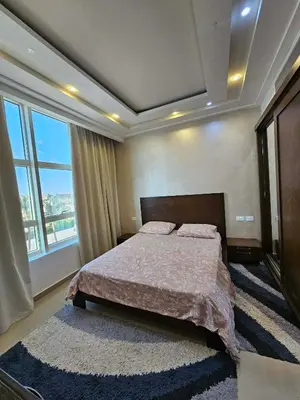 a bedroom with a bed and a large window at touristic center in Hurghada