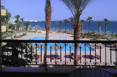 a view of the pool from the balcony of a resort at Luxury flat in Hurghada