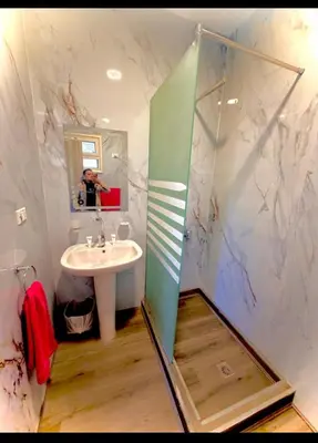 a bathroom with a shower and a sink and a mirror at Luxury flat in Hurghada