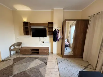 a living room with a flat screen tv and a couch at Hurghada 201 in Hurghada