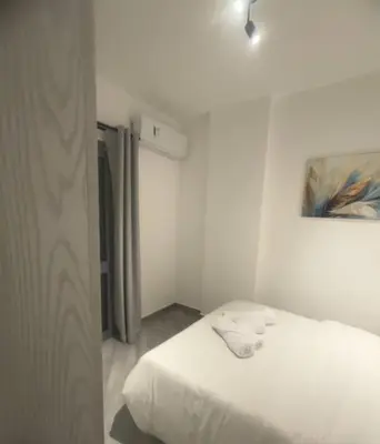 a white room with a bed with towels on it at 422batthepavillionImperialHurghada in Hurghada