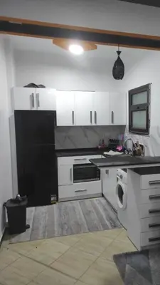 a kitchen with white cabinets and a washer at Modern 1BR Seaside Apartment C1 in Turtles Beach in Hurghada