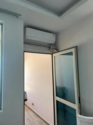 a room with a mirror and a air conditioner on the wall at صف اول على البحر مباشر منطقة القيادات شقة رقم 3 in Hurghada