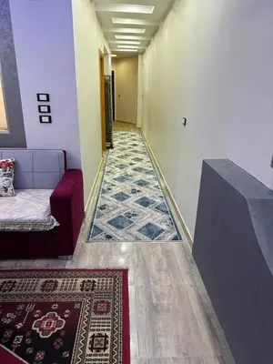 a hallway with a carpet and a couch and a rug at صف اول على البحر مباشر منطقة القيادات شقة رقم 3 in Hurghada