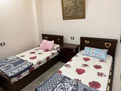 two beds sitting next to each other in a room at صف اول على البحر مباشر منطقة القيادات شقة رقم 3 in Hurghada