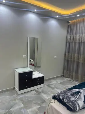 a bedroom with a dresser and a large mirror at القيادات صف ثاني in Hurghada