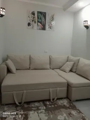 a living room with a brown couch in a room at luxury one bedroom at scandic resort in Hurghada