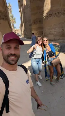 a man and two women standing next to a building at 2 Karima house B in Al Aqālitah