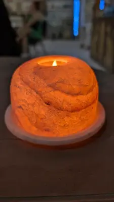 a cake with a candle sitting on a table at 2 Karima house B in Al Aqālitah