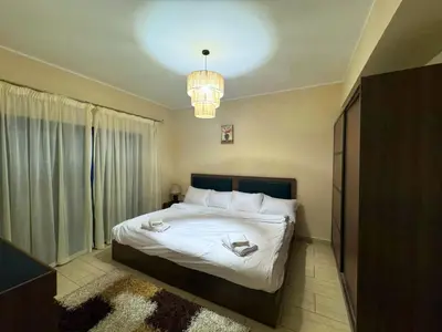 a bedroom with a bed and a chandelier at Decoraive Appartment AlDaU Hurghada in Sahl Hasheesh
