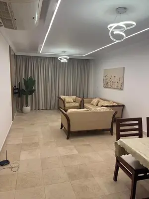 a living room with a couch and a table at Sea front 2 bedrooms apartment in Esplanada in Hurghada