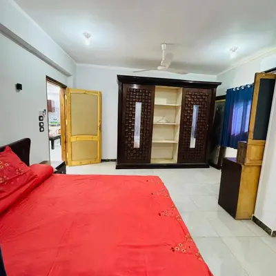 a room with a red carpet and a closet at Many hahaha in Luxor