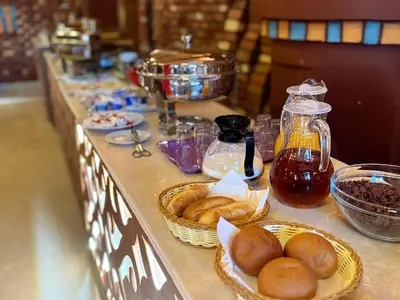 a buffet line with baskets of bread and other food at opal legacy luxor in Luxor