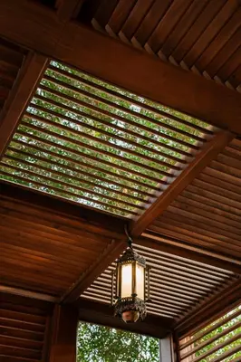 a chandelier hanging from a wooden ceiling in a room at opal legacy luxor in Luxor