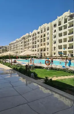 a large apartment building with a large swimming pool at Sahl Hasheesh Finest Chalet - Gravity resort beachfront family 2 bedroom - garden pools view waterpark NON EGYPTIAN ONLY in Hurghada