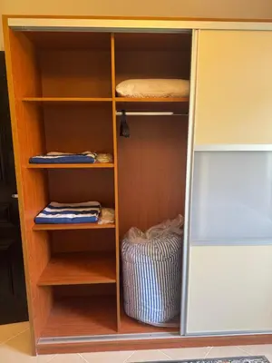 a wooden book shelf with some items in it at Sahl Hasheesh Finest Chalet - Gravity resort beachfront family 2 bedroom - garden pools view waterpark NON EGYPTIAN ONLY in Hurghada