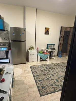 a kitchen with a stainless steel refrigerator at El nour in Hurghada