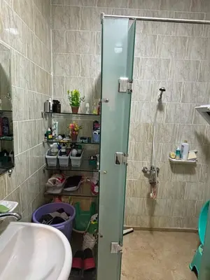 a shower with a glass door in a bathroom at El nour in Hurghada