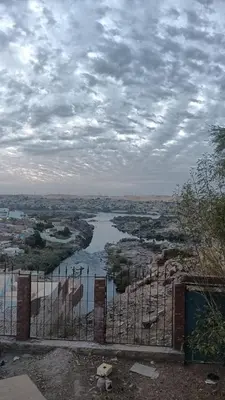 a view of a river from behind a fence at noreno guest house in Aswan