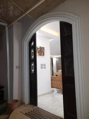 a room with an open door to a bedroom at Private villa with swimming pool in Hurghada