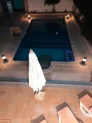 a swimming pool with a statue in front of it at Private villa with swimming pool in Hurghada