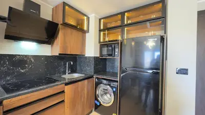 a kitchen with a stainless steel refrigerator and a dishwasher at Galaxy Aldau Hieghts in Hurghada