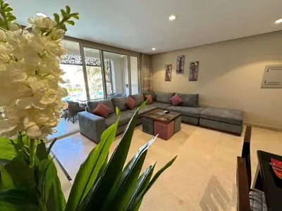 a living room with a couch and a table at Mangarove m3 1c 11 in Hurghada