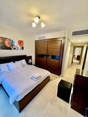 a bedroom with a large bed with a wooden headboard at Mangarove m3 1c 11 in Hurghada