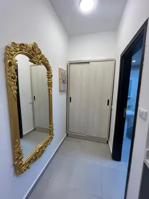a bathroom with a gold mirror on the wall at Benashti Hurghada apartment in Hurghada