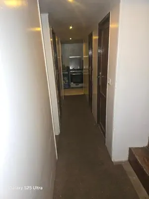a hallway leading to a kitchen in a apartment at The grand in Nag` el-Ramla